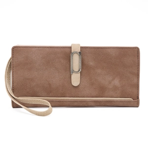 Detail of vintage brown frosted leather wallet with gold buckle and wrist strap