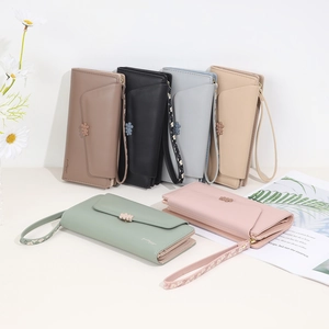 Chic long floral wallet for women featuring daisy accents and a matching wrist strap