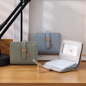 Detail view of RFID women's wallet with leaf charm and quilted pattern card slots