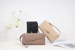 Detailed view of leather floral wallets in long and short styles with hand straps