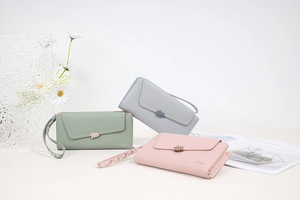 Detailed close-up of floral envelope wallets in pastel colors with matching wrist straps