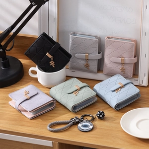 Detailed view of colorful quilted RFID card holders with elegant metal leaf pendants