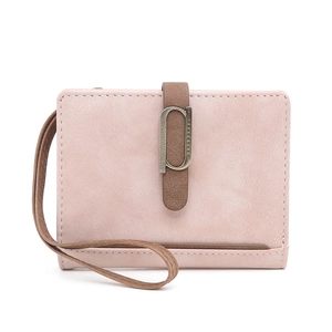 Detail of a dusty rose matte PU leather short wallet with a copper P-clasp and wrist strap