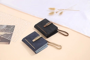 Detail view of vintage frosted PU leather wallets with metallic buckles and wrist straps