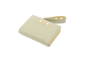 Close-up of light green pebbled leather wallet with heart-shaped gold buckle detail