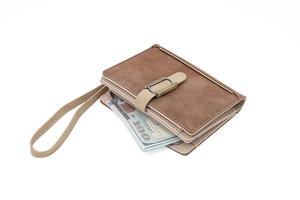 Detail view of brown bifold wallet showing the retro metal buckle and wristlet strap