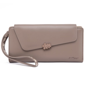 Detail of dusty pink PU leather wallet with asymmetric flap and floral accent piece