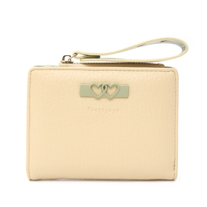 Detailed view of cream leather bifold wallet with dual heart decor and wristlet strap