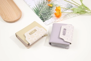 Close-up of yellow and purple PU leather wallets with floral cut-out buckle and metal zipper