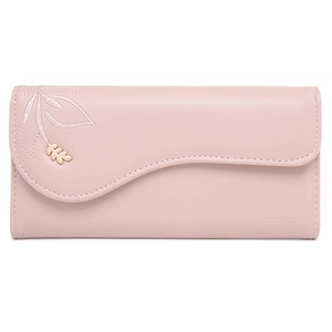 Detail view of pink long wallet featuring scalloped flap edge and gold leaf ornament