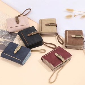 Short vintage wallets in multiple colors with wristlet straps and metal buckles