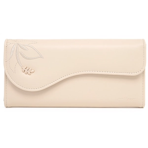 Detail view of wavy flap closure with leaf embroidery and gold charm on cream long wallet