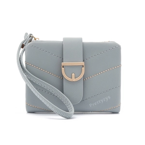 Detail of light blue short wallet with V-quilt pattern and gold D-ring buckle closure
