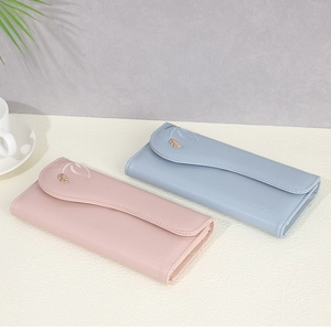 Women's long leather wallet with leaf embroidery and golden pendant in pink and blue
