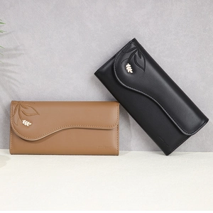 Detail of PU leather wallets with leaf embroidery and scalloped flap edge