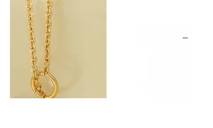 Close-up of high-polish 18K gold plated titanium steel chain with a round OT toggle clasp