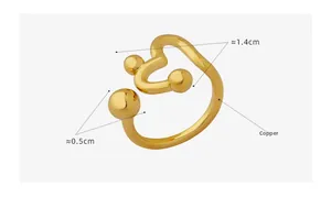 Detailed close-up of golden copper heart open ring with smooth metal ball accents