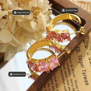 Elegant C-shaped copper earrings plated in 18K gold with sparkling pink square zircons