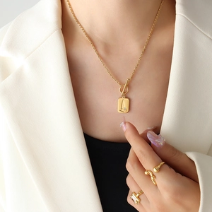 Gold OT buckle necklace with zircon square pendant and matching gemstone ring on model