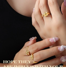 Detail of adjustable gold fox rings showing sleek organic design on a model's hand