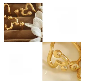 Detailed close-up of golden heart open ring made of premium copper in a velvet box