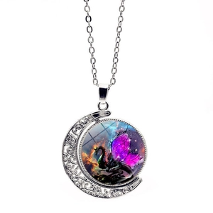 Detail of silver crescent moon necklace featuring a rotating double-sided dragon pendant