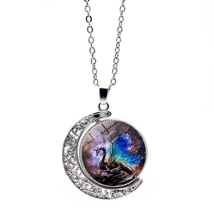 Detailed view of moon pendant with blue dragon artwork and hollow silver metal frame