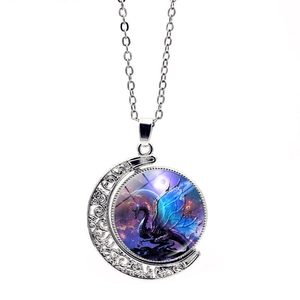 Detailed view of rotating moon pendant with blue dragon motif on silver O-chain