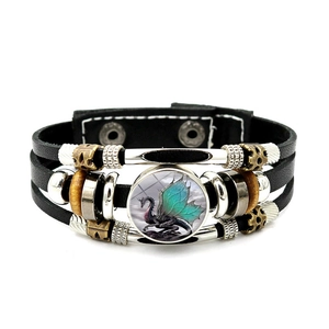 Detail of multi-layer leather bracelet with a teal dragon glass dome and metal buckle
