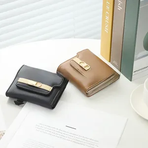Detail of PU leather wallets with gold metal CD clasps in black and brown colors