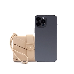 Beige quilted coin purse with wristlet strap shown next to a smartphone for size reference