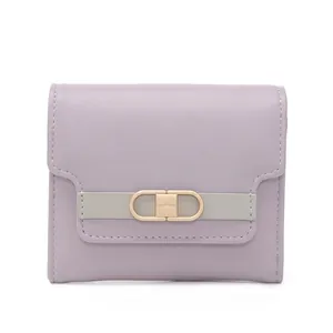 Detailed close-up of light purple synthetic leather wallet with gold buckle clasp
