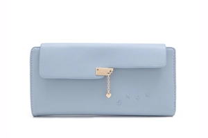Detail of light blue faux leather long wallet with golden buckle and heart-shaped charms