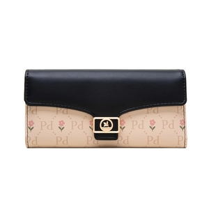 Detail of floral and letter pattern print on long flap wallet with golden leaf buckle