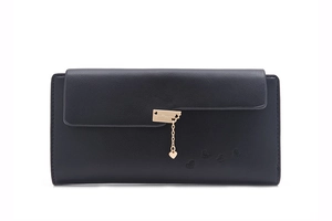 Detail of black leather wallet featuring gold heart pendant and embossed heart patterns