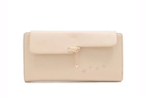 Close-up of beige long wallet featuring heart pendant and delicate embroidery details