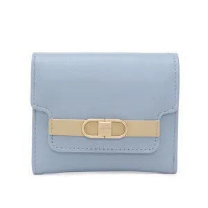 Close-up of light blue trifold wallet featuring golden buckle and Prettysys brand logo