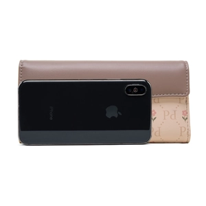 Detailed view of women's long floral wallet size comparison with a smartphone