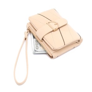 Detail view of cream PU leather wallet with wristlet and metal D-ring closure detail