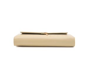 Close-up of beige leather wallet featuring golden heart charm and fine stitching details