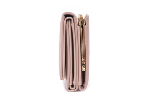 Detail view of pink PU leather tri-fold wallet showing side structure and gold kiss-lock clasp
