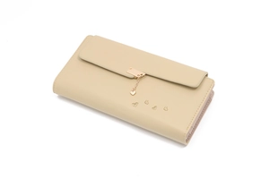Detail of beige long wallet showing heart pendant clasp and embossed texture