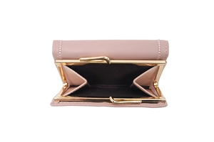 Close-up of pink leather wallet with vintage gold metal clasp and detailed stitching