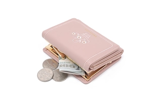 Close-up of pink trifold wallet with floral embroidery and golden metal clasp closure