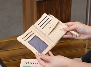 Detail of beige quilted wallet interior with card slots, ID window and wrist strap