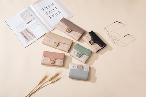 Flat lay of floral print PU leather wallets in diverse colors with golden buckles