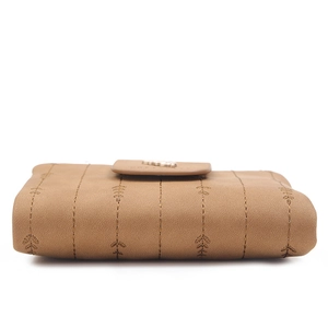 Detail of brown faux leather wallet featuring vertical gold stitching and wheat embroidery
