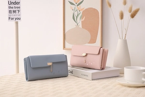 Detail of long tri-fold wallets with heart pendants and butterfly embroidery in Morandi colors
