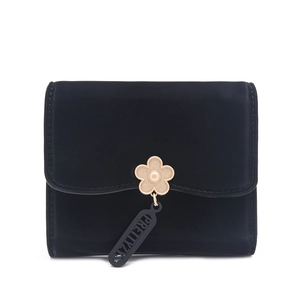 Close-up of black matte leather wallet with golden flower clasp and logo pendant