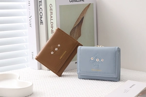 Close-up of trifold PU leather wallets with daisy embroidery and vintage metal clasp